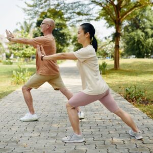 couple practicing tai chi outdoors in the morning